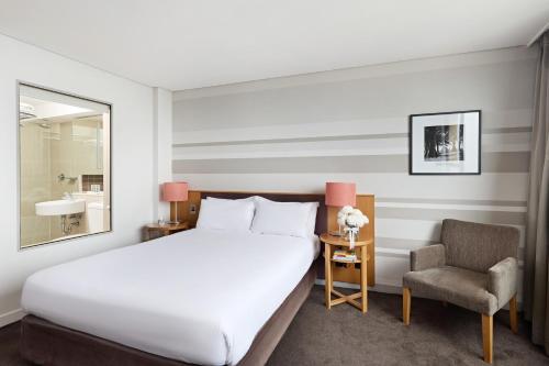 a hotel room with a bed and a chair at View Sydney in Sydney