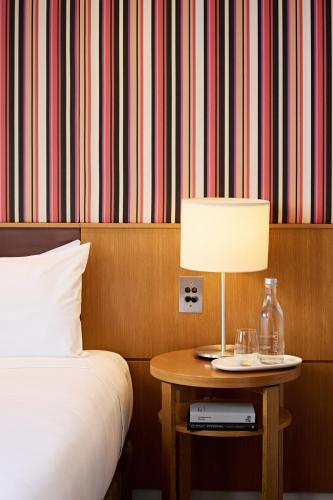 a bedroom with a bed and a table with a lamp at View Sydney in Sydney