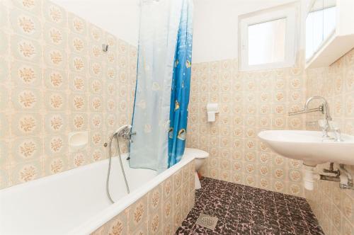 a bathroom with a tub and a sink at Apartments Milan in Vlašići