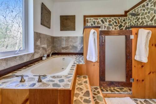 a bathroom with a tub and a sink at The Great Escape - Hamptons Serene Family Favorite in Sagaponack