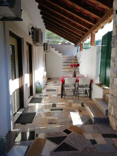 a patio with a table and chairs on a tile floor at Apartments Rogac in Rogač