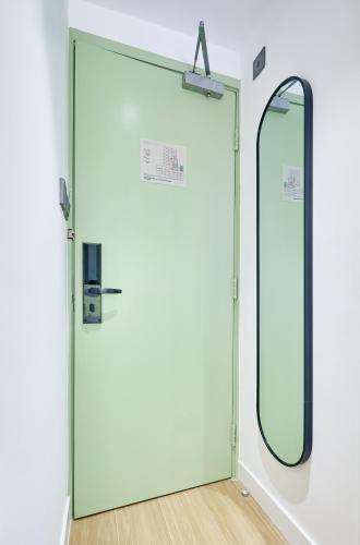 a glass door in a room with a mirror at South Nest in Hong Kong