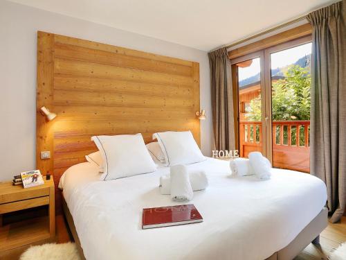 a bedroom with a large white bed with a window at Chalet Courchevel, 5 pièces, 10 personnes - FR-1-575-149 in Courchevel