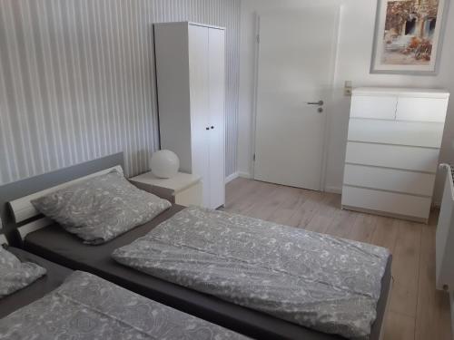 a bedroom with two beds and a closet at Cozy Apartment in Neubukow near Water Sports in Neubukow