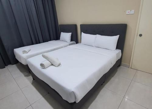 two beds sitting next to each other in a room at Pusat Belia Antarabangsa in Kuala Lumpur