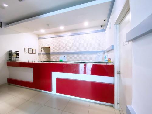 a red and white counter in a kitchen at D'concept Hotel Kulim in Kulim
