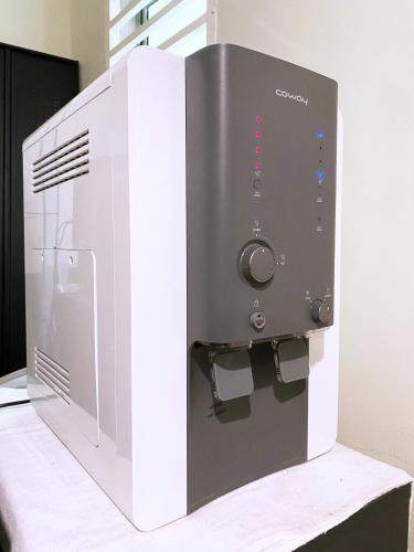 a microwave oven sitting on top of a table at D'concept Hotel Kulim in Kulim