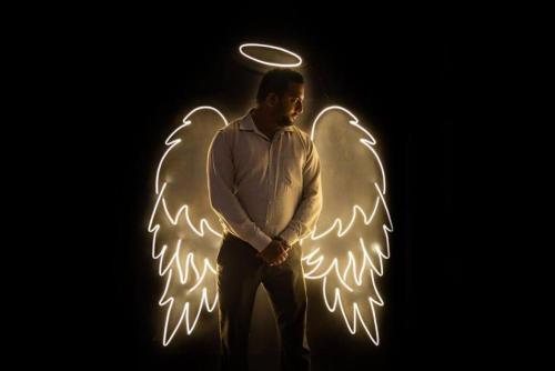 a man wearing angel wings with a frisbee at Luxurious Villa with Private Swimming Pool, Kids Pool, Games, Private Parking in Calangute