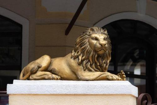 a statue of a lion sitting in front of a building at Luxurious Villa with Private Swimming Pool, Kids Pool, Games, Private Parking in Calangute