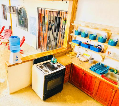 a kitchen with a stove and a sink at Casa Karma in Puerto Escondido