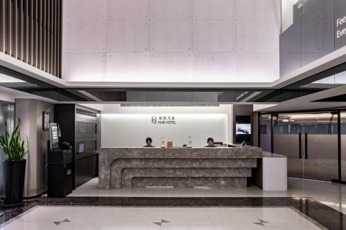a lobby with a reception desk in a building at Hub Hotel - Songshan Airport Branch in Taipei