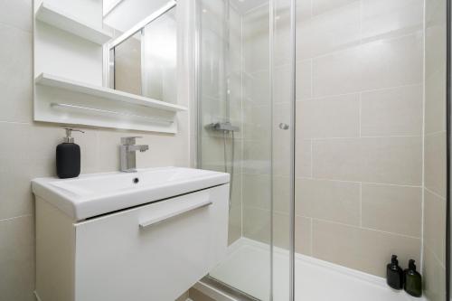 a white bathroom with a sink and a shower at Your Own House, 2 Bedr, 3 Beds, 2,5 Bath, Covent Gdn in London