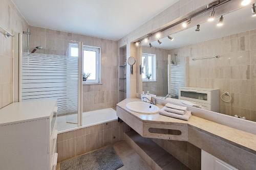 a bathroom with a sink and a shower and a tub at Penthouse Rentalbufeira in Albufeira