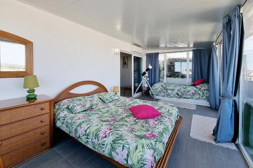 a bedroom with two beds and a dresser and a window at Penthouse Rentalbufeira in Albufeira