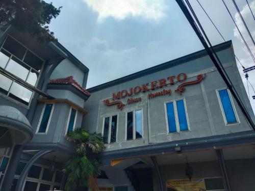 a building with a sign for a restaurant at Mojokerto Classic Homestay in Mojokerto