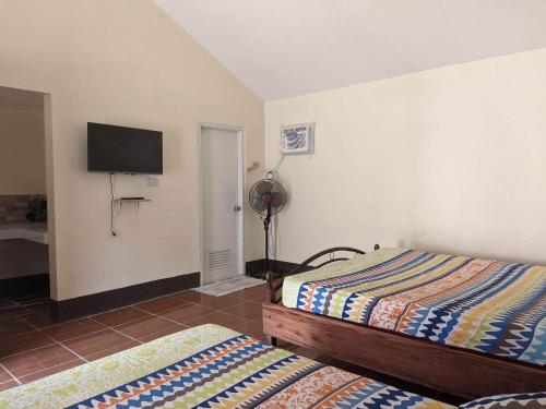 Postel nebo postele na pokoji v ubytování Miguel's Homestay