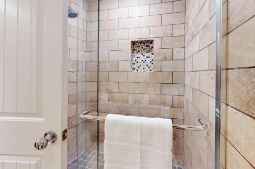 a bathroom with a shower with a white towel at Sidewinder Sunshine in Park City