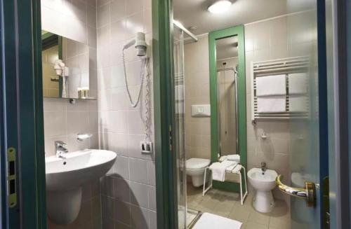 a bathroom with a sink and a toilet at Olimpic Village TH Sestriere apartments in Sestriere