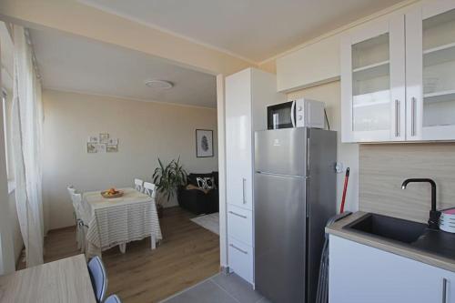 a kitchen with a refrigerator and a table in a room at SuperB apartment with incredible view at the best location in Veszprém