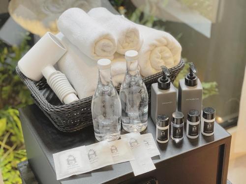 a basket of towels and bottles on a table at S.House168 in Chiang Mai