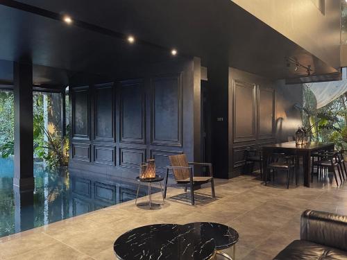 a living room with a table and chairs at S.House168 in Chiang Mai