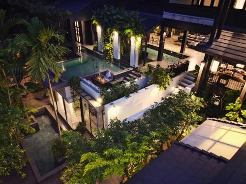 an overhead view of a swimming pool at night at S.House168 in Chiang Mai