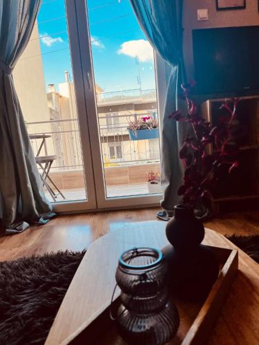 a room with a large window and a table at Evenos in Kavala
