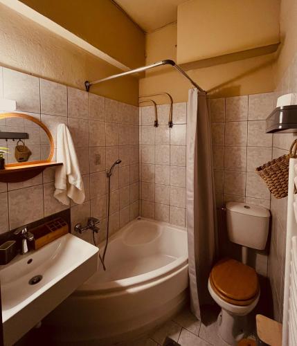 a bathroom with a tub and a toilet and a sink at Evenos in Kavala