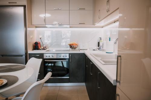 a small kitchen with a sink and a stove at Nafplio Pleasure Stay Ι in Nafplio
