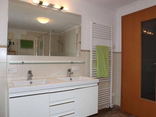 a bathroom with a sink and a mirror at Holiday flat Sonnau, Bramberg am Wildkogel in Bramberg am Wildkogel