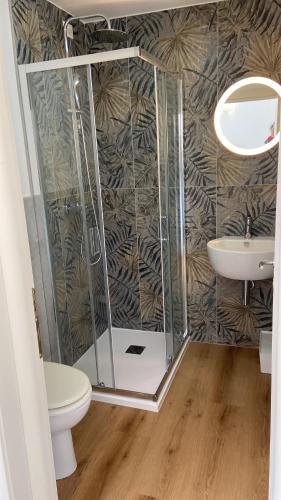 a bathroom with a shower and a toilet and a sink at Civico 28 in Pescara