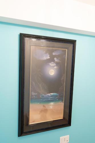 a painting of a beach scene on a wall at Japan Hinata Hotel 池下駅 1番出口 徒歩2分 1LDK 50平米 8名 in Nagoya