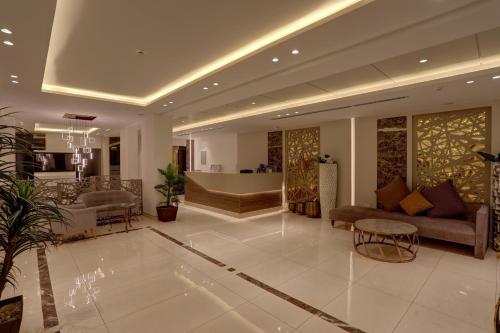 a living room with a couch and a table at Mass Paradise Hotel in Aqaba