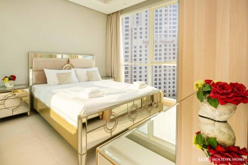 a bedroom with a bed and a window at LUX - The JBR Dubai Eye Suite in Dubai