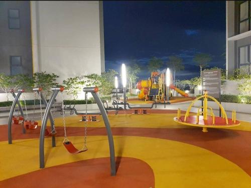a play area with swings and a playground at The Glass Homestay Putrajaya in Putrajaya