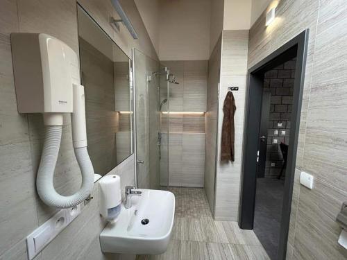a bathroom with a white sink and a shower at Penzion Kunc - Ubytování v soukromí - Borová 607, Příbram - Střední Čechy in Příbram