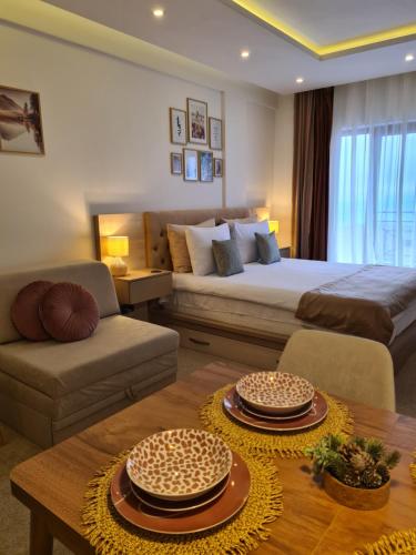 a living room with a large bed and a table at Mountain Side Kopaonik in Kopaonik