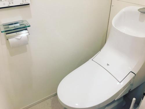 a bathroom with a white toilet and a sink at Ken's Place四谷 in Tokyo