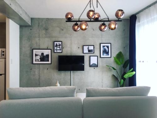 a living room with a couch and a tv at Ken's Place四谷 in Tokyo