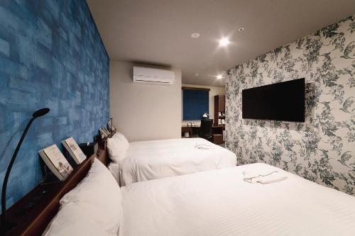 東京にあるNo, 2 Taniji Building - Vacation STAY 91347vのベッド2台、薄型テレビが備わるホテルルームです。