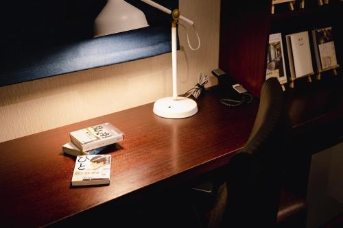 a desk with a lamp and a book on it at No, 2 Taniji Building - Vacation STAY 91347v in Tokyo