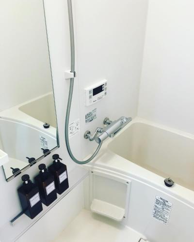 a bathroom with a shower and a sink at Ken's Place四谷 in Tokyo