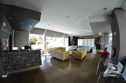 a living room with couches and chairs in a building at Madeira Bright Star by Petit Hotels in Funchal