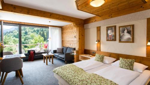 a bedroom with a bed and a living room at Chalet Edelweiß in Pfronten