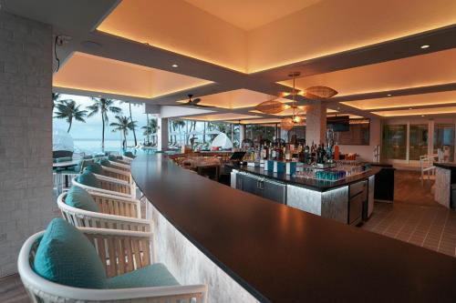 a bar at a resort with chairs and a counter at Crowne Plaza Resort Guam in Tumon