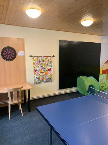a classroom with a blackboard and a table and chairs at Rodinný penzion Skiland in Ostružná