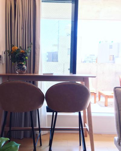 a table and two chairs in front of a window at Ken's Place四谷 in Tokyo