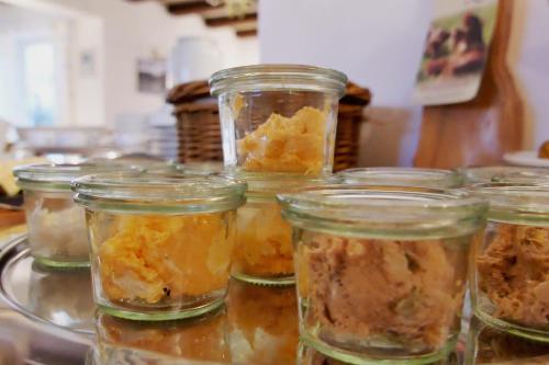 a group of jars of food sitting on a counter at Hotel Berlin Tegernsee in Rottach-Egern