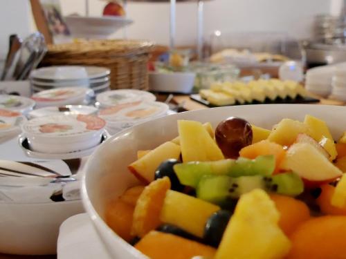 a bowl of fruit and vegetables on a table at Hotel Berlin Tegernsee in Rottach-Egern
