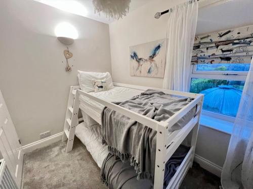 a white bed in a room with a window at Bank View next to the Fleece Countryside Inn in Barkisland